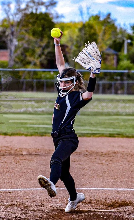 Fastpitch softball pitcher mid-windmill delivery