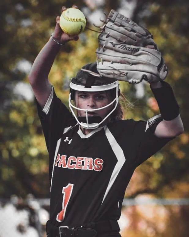 Fastpitch softball pitcher at top of windmill motion